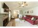 Bright living room with fireplace, vaulted ceiling, wood flooring, and comfortable seating arrangement at 7925 Silversmith Dr, Cumming, GA 30028