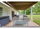 Inviting outdoor patio area with a pergola, modern furniture, and a spacious backyard at 7925 Silversmith Dr, Cumming, GA 30028