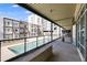 Long balcony view showcasing seating and a community pool below surrounded by modern building exteriors at 890 Memorial Se Dr # 105, Atlanta, GA 30316