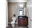Bathroom with black granite countertop, wood cabinets, and gray tile floor at 890 Memorial Se Dr # 105, Atlanta, GA 30316