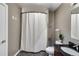 Neutral bathroom featuring a tiled floor, modern fixtures, and bathtub with shower at 890 Memorial Se Dr # 105, Atlanta, GA 30316