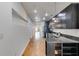 Galley kitchen featuring granite countertops, stainless steel appliances and sleek black cabinetry at 890 Memorial Se Dr # 105, Atlanta, GA 30316