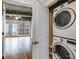 View of the laundry closet with a stacked washer and dryer, and a large open space nearby at 890 Memorial Se Dr # 105, Atlanta, GA 30316