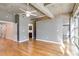 Open concept living room with hardwood floors, industrial ceilings, and multiple entryways at 890 Memorial Se Dr # 105, Atlanta, GA 30316