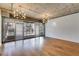 Spacious living room with exposed ceiling, hardwood floors, and doors to a private balcony at 890 Memorial Se Dr # 105, Atlanta, GA 30316