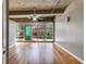 Bright living room with hardwood floors and a wall of windows, industrial ceilings with exposed beams at 890 Memorial Se Dr # 105, Atlanta, GA 30316