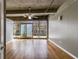 Bright living room with hardwood floors and a wall of windows, industrial ceilings with exposed beams at 890 Memorial Se Dr # 105, Atlanta, GA 30316
