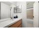 Bright bathroom with wood vanity, large mirror, and shower with tiled walls at 907 Parkaire Xing, Marietta, GA 30068