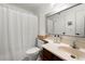 Bathroom featuring tiled floors, vanity with sink, mirror, and shower with a white curtain at 907 Parkaire Xing, Marietta, GA 30068