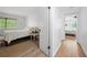 Bright bedroom featuring a comfortable bed, natural light, and warm wood floors at 907 Parkaire Xing, Marietta, GA 30068