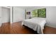 Inviting bedroom with light walls, wood floors, natural light, closet, and window views at 907 Parkaire Xing, Marietta, GA 30068