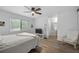 Light bedroom featuring a ceiling fan, a bright window, and wood look flooring at 907 Parkaire Xing, Marietta, GA 30068