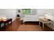 Cozy bedroom featuring warm wood floors, a large window, and eclectic decor at 907 Parkaire Xing, Marietta, GA 30068