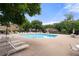 Well-maintained community pool with lounge chairs, tables, and umbrellas for a relaxing outdoor experience at 907 Parkaire Xing, Marietta, GA 30068