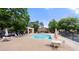 View of the sparkling community pool with lounge chairs and tables, perfect for relaxation and socializing at 907 Parkaire Xing, Marietta, GA 30068