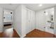 Hallway with a closet, wood floors, and views of the bedroom and bathroom at 907 Parkaire Xing, Marietta, GA 30068
