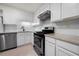 Well-lit kitchen featuring white cabinets, subway tile backsplash, stainless steel dishwasher and black gas range at 907 Parkaire Xing, Marietta, GA 30068