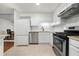Bright kitchen with white cabinets, stainless steel appliances and tan countertops at 907 Parkaire Xing, Marietta, GA 30068