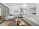 Open living room with modern sofa, wood floors, and sliding glass door at 907 Parkaire Xing, Marietta, GA 30068