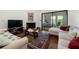 Bright living room features sliding glass doors to balcony, fireplace and hardwood floors at 907 Parkaire Xing, Marietta, GA 30068