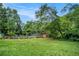 Spacious backyard featuring a pool, lush lawn and mature trees at 100 Biscayne Nw Dr # A1, Atlanta, GA 30309