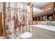 Bathroom with a cowboy-themed shower curtain and wooden shelving at 100 Biscayne Nw Dr # A1, Atlanta, GA 30309