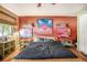 Bedroom featuring a bed with a dark cover, colorful artwork, and light green side tables at 100 Biscayne Nw Dr # A1, Atlanta, GA 30309