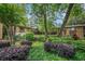 Brick building exterior boasts lush landscaping with mature trees and manicured shrubs at 100 Biscayne Nw Dr # A1, Atlanta, GA 30309