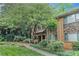 Inviting brick townhome with stone accents and lush landscaping, providing a serene and welcoming curb appeal at 100 Biscayne Nw Dr # A1, Atlanta, GA 30309