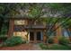 Charming brick townhome featuring stone accents and a well-manicured front yard with mature trees and lush greenery at 100 Biscayne Nw Dr # A1, Atlanta, GA 30309