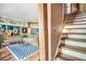 Cozy living room featuring unique artwork, a comfortable sofa, and a staircase leading to the upper level at 100 Biscayne Nw Dr # A1, Atlanta, GA 30309