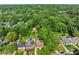 An aerial view captures a home nestled in a leafy neighborhood with an in-ground pool, shed and manicured lawn at 239 Kings Hwy, Decatur, GA 30030