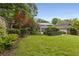 Expansive backyard featuring an indoor pool room, a lush lawn, and mature trees, offering privacy at 239 Kings Hwy, Decatur, GA 30030