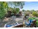Backyard patio featuring a dining set, lounge chairs, and lush landscaping at 239 Kings Hwy, Decatur, GA 30030