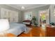 Bright bedroom with hardwood floors and a large window with shutter, filled with natural light at 239 Kings Hwy, Decatur, GA 30030