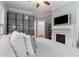 Bright bedroom with white and blue walls featuring a fireplace, ceiling fan, and a large wardrobe at 239 Kings Hwy, Decatur, GA 30030