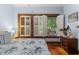 Bedroom with wood-framed window, white shutters, hardwood floors, and light blue walls at 239 Kings Hwy, Decatur, GA 30030