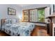 Bright bedroom with hardwood floors and a large window with shutter, filled with natural light at 239 Kings Hwy, Decatur, GA 30030