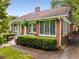 Charming brick home with a welcoming entrance, manicured hedges, and beautiful stained glass windows at 239 Kings Hwy, Decatur, GA 30030