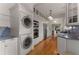 Galley kitchen featuring washer/dryer, stainless steel appliances and marble countertops at 239 Kings Hwy, Decatur, GA 30030