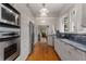 Galley kitchen featuring stainless steel appliances, hardwood floors, and stylish countertops at 239 Kings Hwy, Decatur, GA 30030
