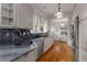 Bright galley kitchen with stainless steel appliances, marble countertops, and custom cabinetry at 239 Kings Hwy, Decatur, GA 30030