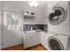 Utility room with washer/dryer, stylish utility sink, and access to the backyard at 239 Kings Hwy, Decatur, GA 30030