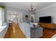 Bright living room featuring hardwood floors, built-in storage, and an open view to the kitchen at 239 Kings Hwy, Decatur, GA 30030