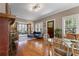 Open-concept living and dining areas with hardwood floors, fireplace, and sunroom views for easy living at 239 Kings Hwy, Decatur, GA 30030