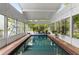 Indoor pool showcasing its elongated shape and the surrounding sunroom at 239 Kings Hwy, Decatur, GA 30030