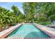 Backyard swimming pool surrounded by lush greenery and a patio with seating at 239 Kings Hwy, Decatur, GA 30030
