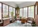 Cozy sunroom with brick walls, vintage windows, and an assortment of plants for a serene retreat at 239 Kings Hwy, Decatur, GA 30030