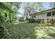 The rear exterior of the property offers an ample yard that is surrounded by trees at 2820 Georgian Ter, Marietta, GA 30068