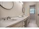 Bathroom with double vanity, light countertop, dual sinks, and white cabinets at 2820 Georgian Ter, Marietta, GA 30068